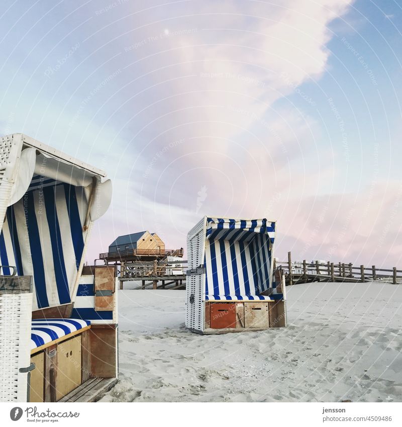 Beach chairs and a new pile building on the beach of St. Peter-Ording North Frisland Schleswig-Holstein North Sea Sand Relaxation Tourism Vacation & Travel