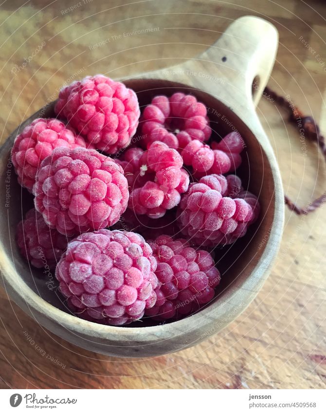frozen raspberries in a wooden cup Raspberry Frozen Fruit Food Delicious Dessert cute Tasty Colour photo Close-up Berries Fresh Red freezing cold naturally