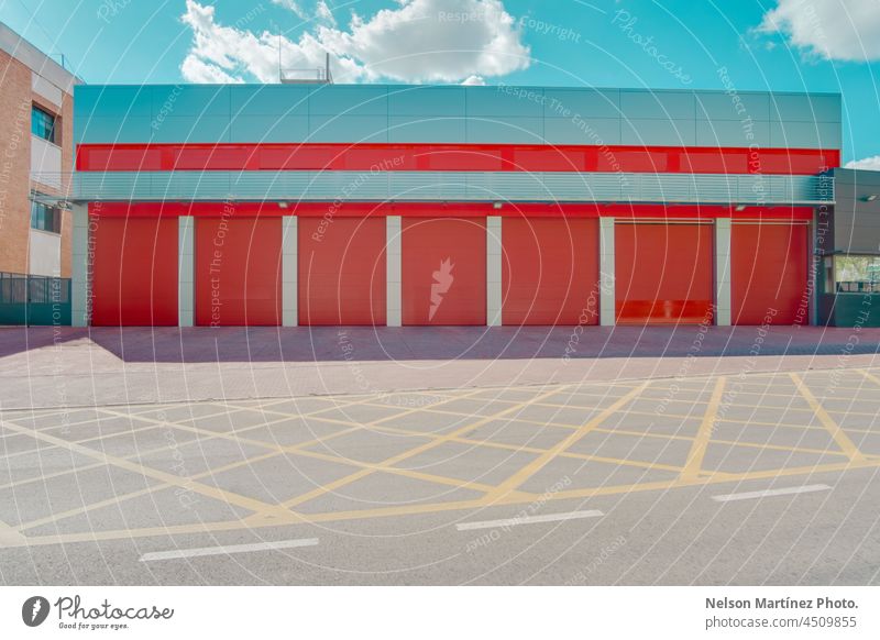 Red warehouse with closed roller shutter door red factory sky minimal minimalism blue storage architecture building siding steel industrial garage engineering