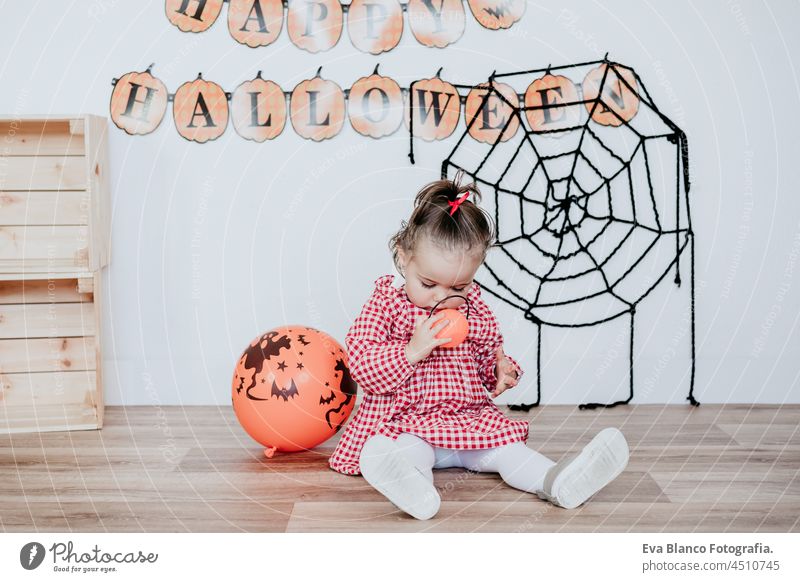 beautiful one year old caucasian girl at home with Halloween decoration, Lifestyle indoors. Halloween party concept. halloween costume happy studio gorgeous 1