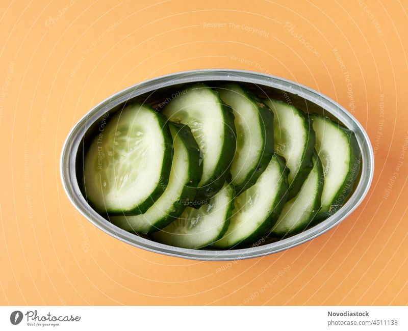 can with fresh cucumber slices, isolated, with copy space canned canned food tin vegetables healthy healthy food tinned food green vegetarian vegan diet concept