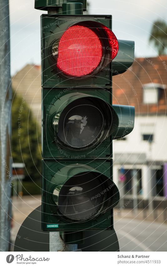 The traffic light is on red Traffic light Red Red light Road sign forbidden stop Transport Road traffic Traffic infrastructure Town Colour photo Exterior shot
