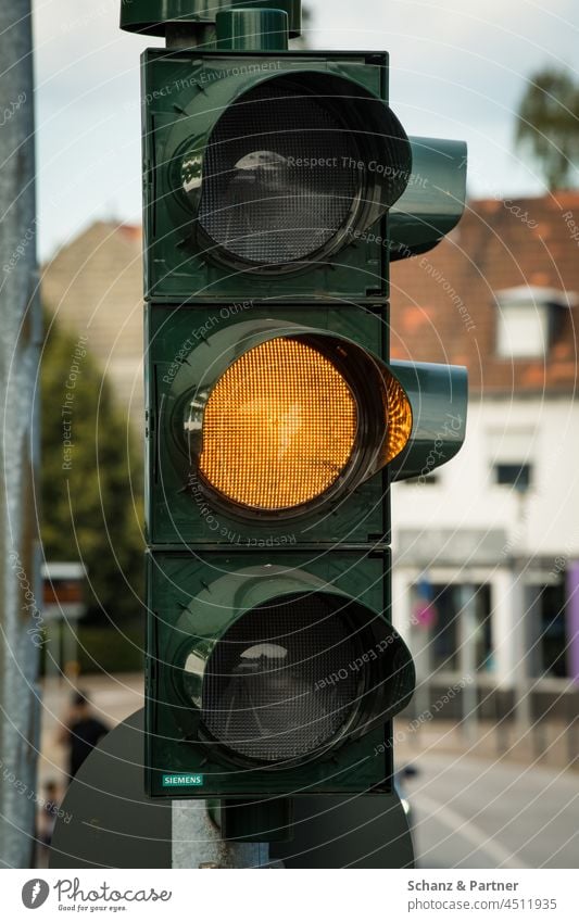 the traffic light is yellow Traffic light Yellow yellow light Road sign forbidden stop Transport Road traffic Traffic infrastructure Town Colour photo