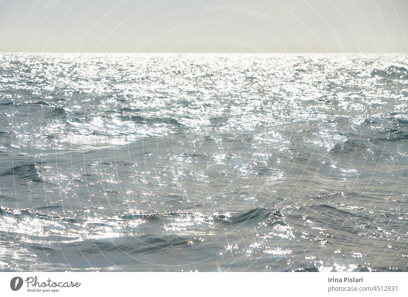 Horizon sea with waves after storm. sparkler in water - background. sea water with sun glare and ripple. Powerful and peaceful nature concept. blue coastline