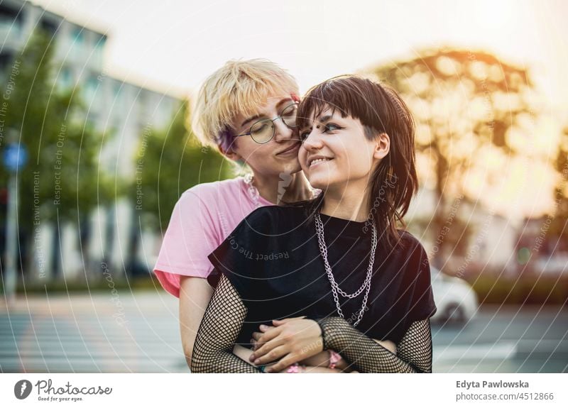 Young gender fluid couple hugging on city street homosexual couple love together romantic queer non-binary lgbt equality millennials gender-blend transgender