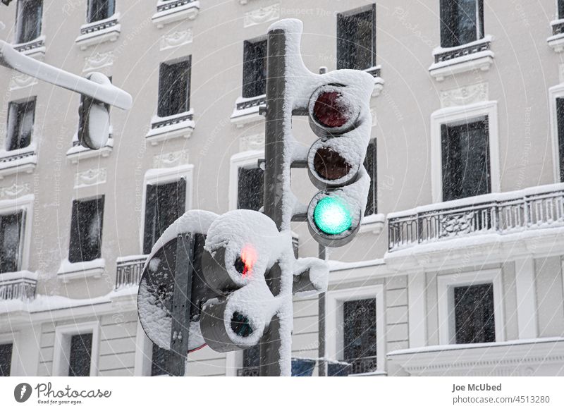Snowy traffic light on green on a snowy winter day car caution closed cold ice nature open outdoor passing pedestrian respect sign sky street street light
