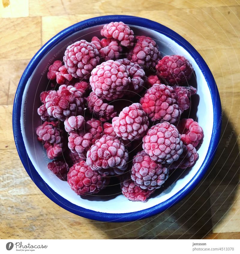 frozen raspberries in a white-blue enamel bowl Raspberry Fruit Food Healthy Nutrition Red Fresh Berries Delicious Close-up Colour photo cute Vegetarian diet