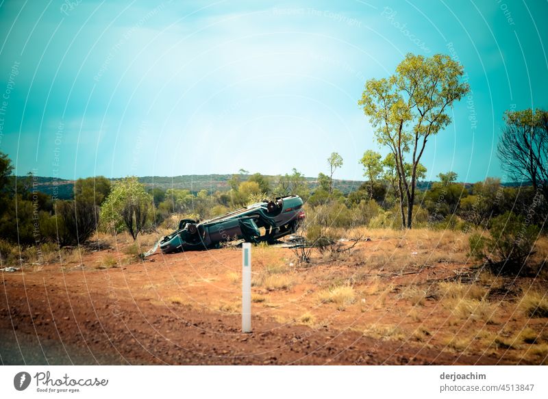 Serious accident in the outback. The car lies smashed on its roof on the side of the road. Accident Broken Deserted Colour photo Exterior shot Day Damage