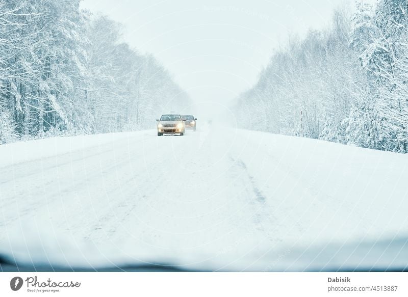 Snowy road in winter forest with moving car weather snowy transport ice outdoor frost vehicle auto automobile blizzard brake cold country crash danger drift