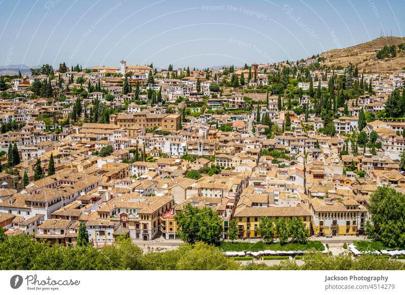 Granada cityscape viewed from Alhambra palaces complex, Andalusia, Spain granada architecture urban skyline alhambra trees green orange hills houses typical