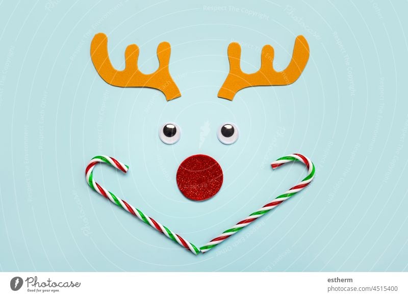 Merry Christmas. Christmas Rudolph reindeer horns with false eyes and striped candy canes. Christmas concept background christmas santa claus fun celebration