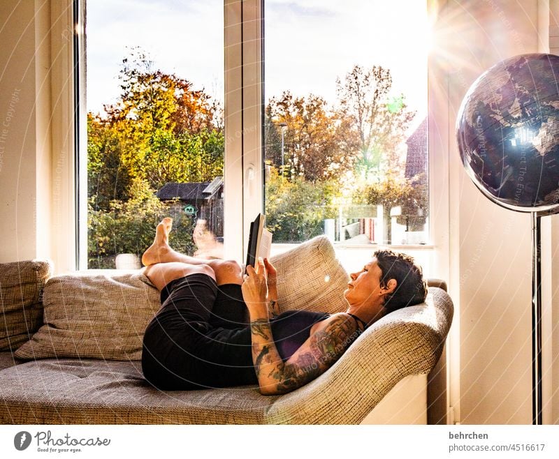 THE LIGHTNESS OF BEING Window at home Bookworm Dream To enjoy dwell Tattoo tattooing Tattooed tattoos Warmth Back-light Sunbeam Sunlight concentrated Woman