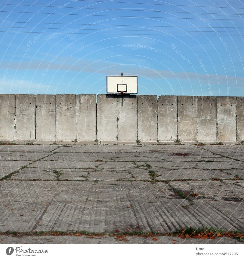 Objective - basketball hoop on sunny factory premises with old concrete walls and worn-out factory yard Basketball Basketball basket Concrete wall