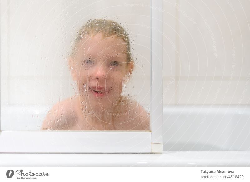 Boy playing in bathroom child water fun kid bathtub washing boy face childhood shower person happiness joy home lifestyle indoors caucasian
