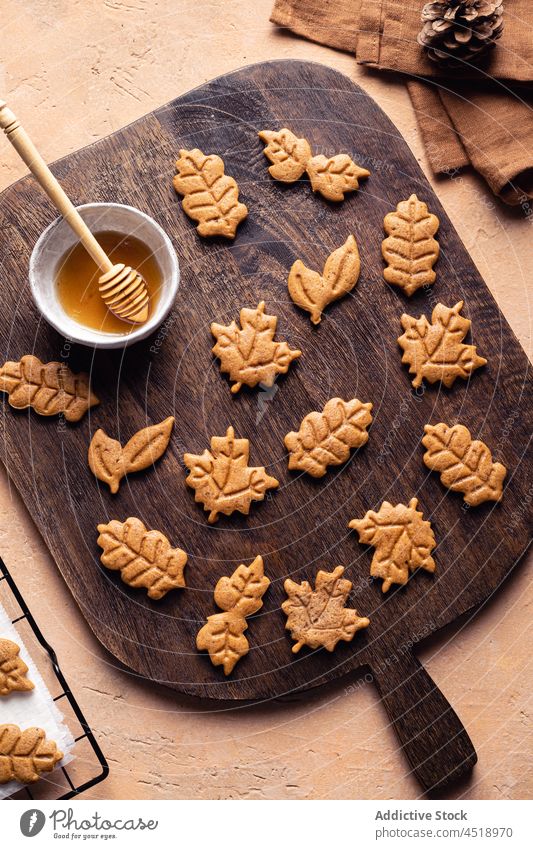 Leaf shaped cookies with honey dessert cutting board baked sweet homemade culinary pastry leaf autumn confection tasty table delicious yummy confectionery
