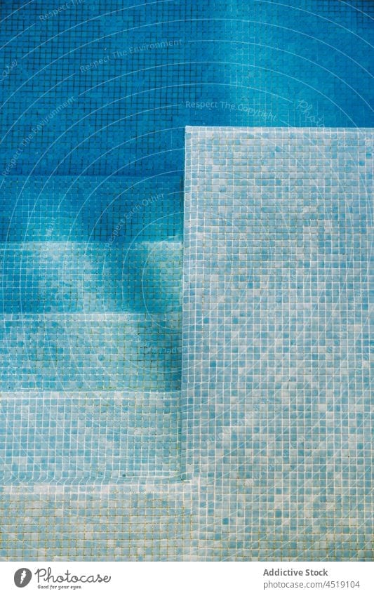 Clear transparent water in swimming pool blue tile clear clean summer bottom crystal pure poolside liquid turquoise resort stairway translucent azure part