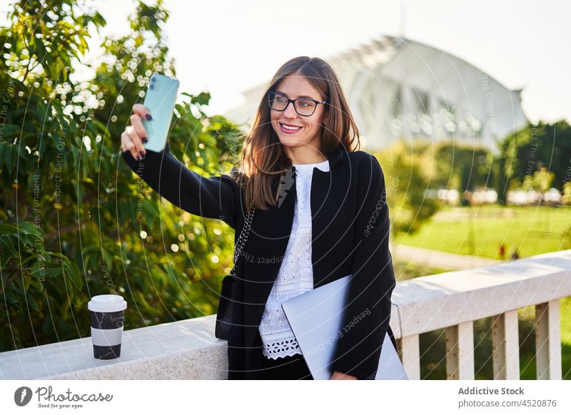 Smiling woman taking selfie on smartphone on bridge worker using style positive formal elegant female self portrait businesswoman executive laptop gadget