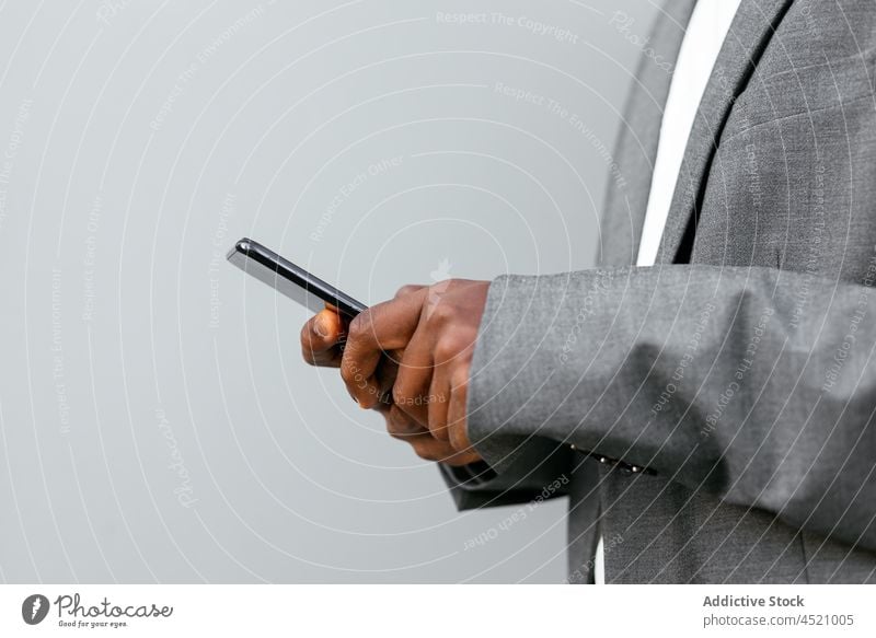 Black executive man browsing smartphone businessman using formal connection online suit listen music male device worker mobile entrepreneur black
