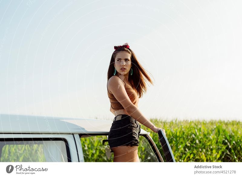 Beautiful and happy brunette girl standing on a van on a sunny d pretty cute woman young youth caravan outside road cornfield looking summertime leisure