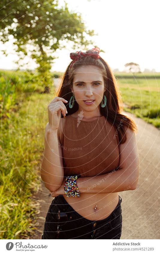 Beautiful brunette girl in summer clothes on a sunny day standin woman tanned caucasian portrait standing summertime outdoors colorful warm wide open prairie