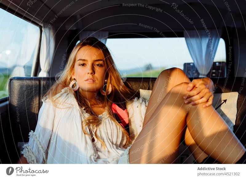 Attractive blonde girl inside a vintage van and lying on the seat on a sunny day attractive sensual pretty woman female caucasian sitting relaxed sunset caravan