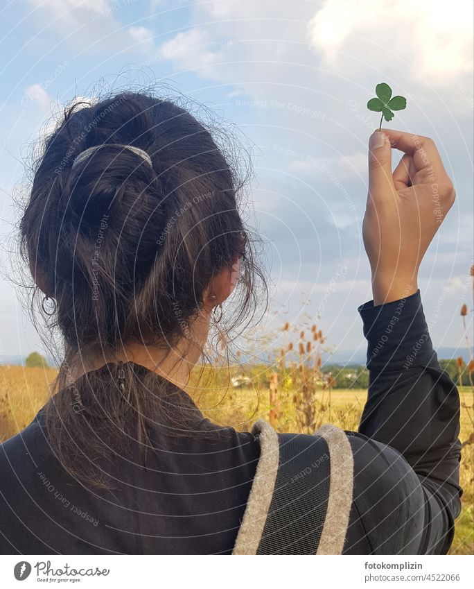 Happiness - woman holding up four leaf clover Happy Cloverleaf Four-leaved Four-leafed clover Good luck charm Desire Seldom happy woman fortunate Nature Woman