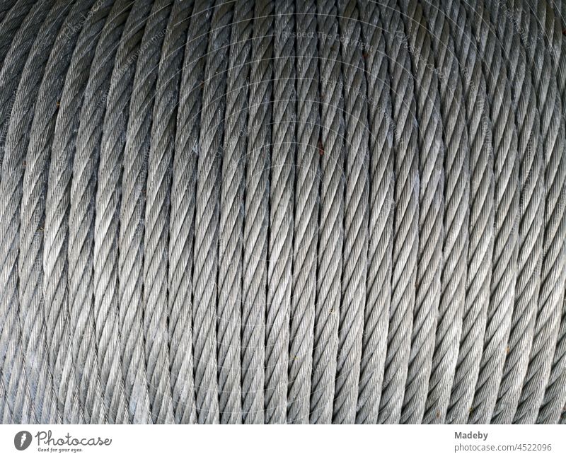 Coiled silver shining steel rope in a climbing park in Bielefeld in the Teutoburg Forest in East Westphalia-Lippe steel cable Rope Climbing rope Bouldering