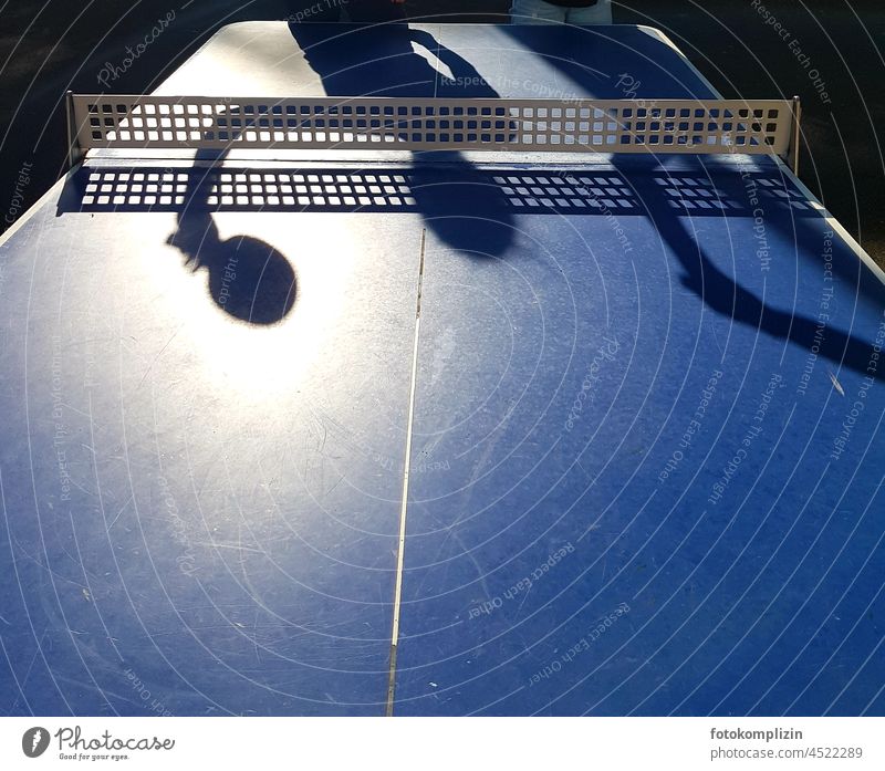Table tennis: shadow of a person with racket on the blue table tennis table Table tennis table Table tennis bat Table tennis net Table tennis game Net