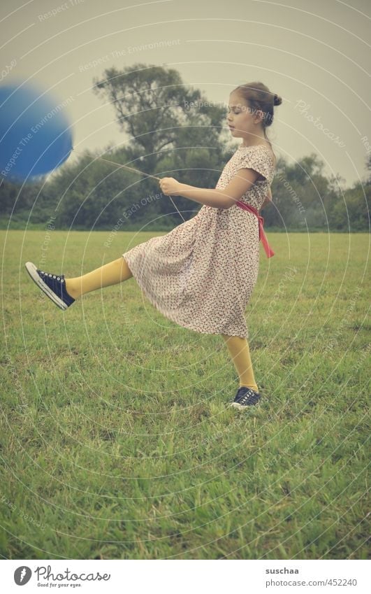 the blue balloon .. Child Girl Dress Arm Legs Feet Hand Exterior shot Playing Meadow Grass Balloon Retro young girl Infancy playfulness Family party Funny drama