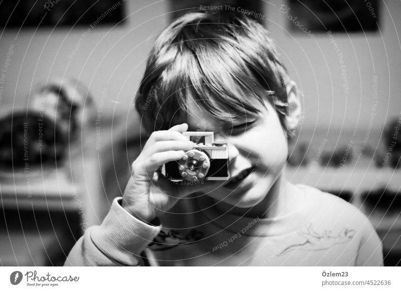 Child taking pictures with toy camera Infancy child childhood Photography Camera Black & white photo Son Boy (child) son Exterior shot Love Close-up Face
