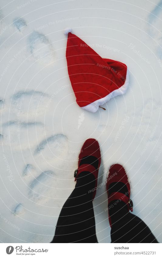 Santa hat in the snow and women legs Winter Cold Snow Santa Claus Santa Claus hat Christmas & Advent Anticipation Tradition Kitsch winter footprints