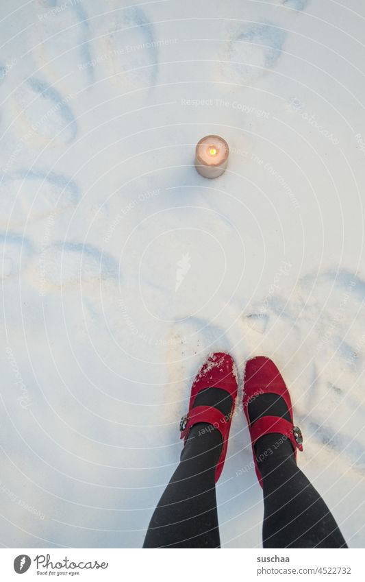 burning candle in the snow, in addition red-shod women's legs Woman standing Legs feet Footwear Red High heels feminine Winter Snow shoulder stand