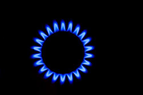 Blue gas flame of kitchen stove in bird's eye view against black background Gas flame Kitchen stove Stove Bird's-eye view Black Isolated Image Energy