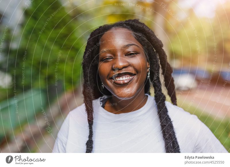 Portrait of smiling young woman outdoors unaltered natural real people authentic body inclusivity body positive one person hipster girl hairstyle dreadlocks