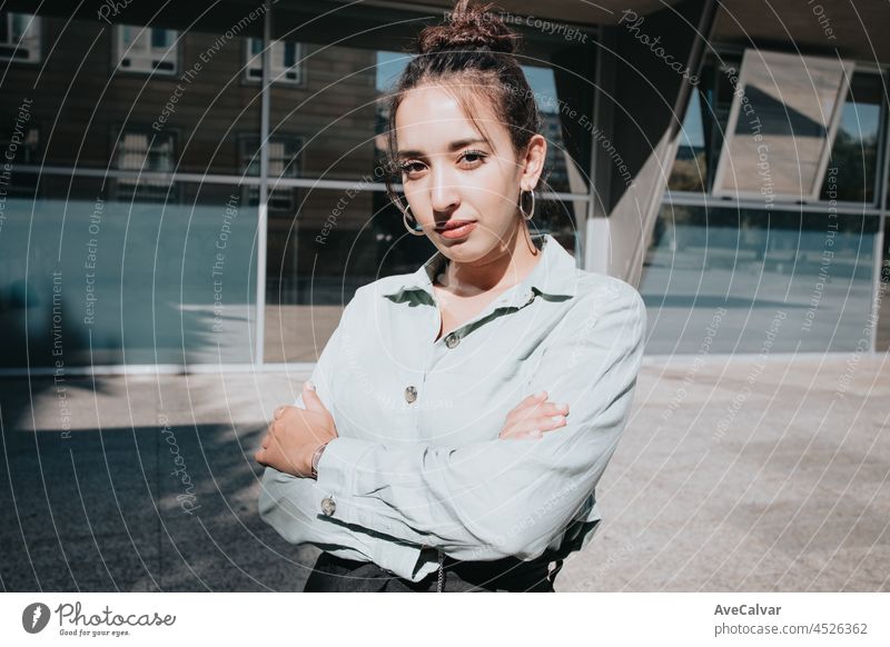 Young arab woman entrepreneur woman, crossing arms while looking serious to camera, outdoors. Business concept, portrait of office businesswoman young laptop