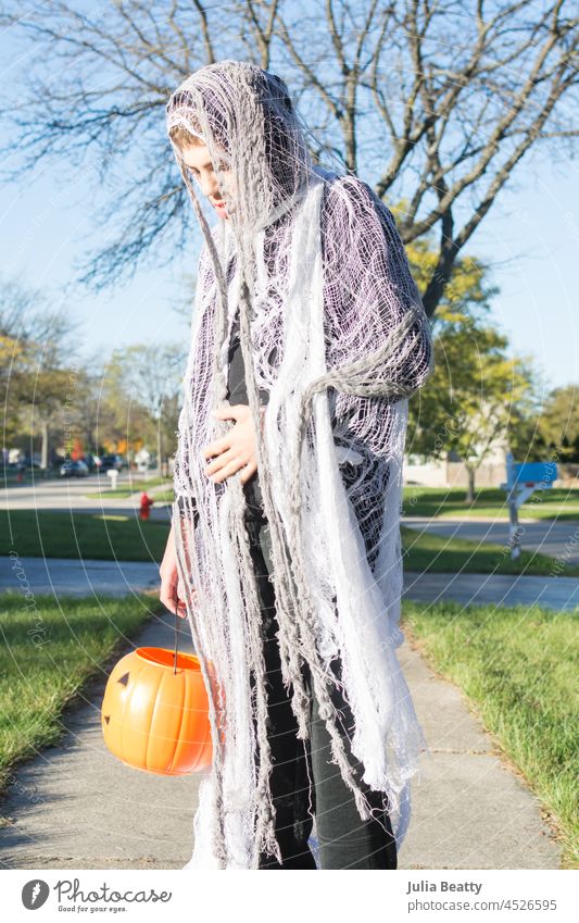 Boy with Autism wearing a D.I.Y ghost costume to go trick or treating for Halloween halloween drape creepy spirit cheesecloth d.i.y. affordable holiday autumn