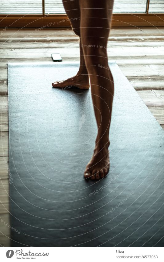 Man legs on a yoga mat Yoga yoga exercise at home Naked Lifestyle Cellphone Telephone Fitness wooden floor Black Yoga posture Body Human being Legs Male Legs