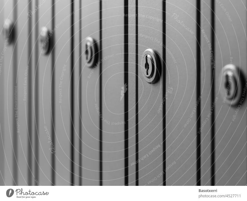 Close-up of a row of lockers or letterboxes Lock Locks Lockbox Mailbox Gray Black & white photo Narrow Tall nobody Deserted Detail Key Day Keyhole Safety Metal