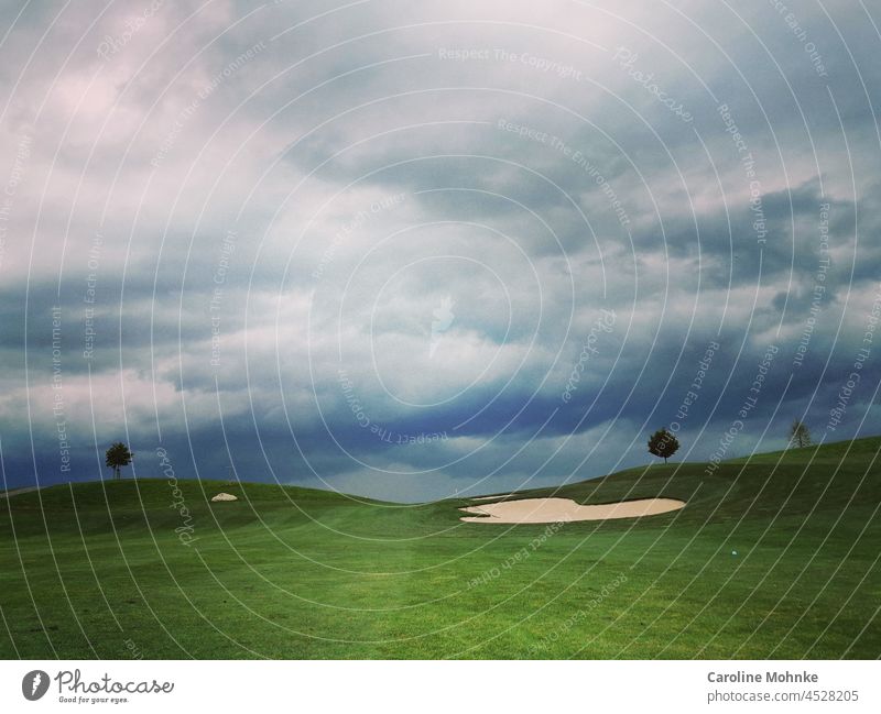 Bunkers, trees, clouds - atmospheric round of golf Golf Sports Clouds Golf course Golf ball Playing Green Ball Leisure and hobbies Exterior shot Colour photo