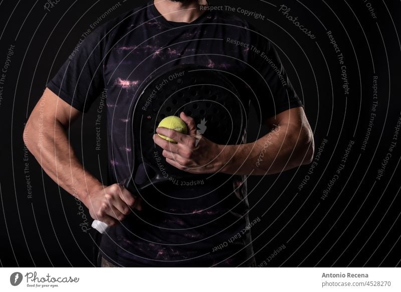 Man ready for paddle tennis serve in studio shot, anonymous pose man padel sport player fit 40s 35-39 years mid adult male bearded arab people person racket