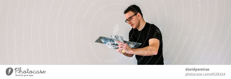 Builder working picking plaster with spatula builder plasterer picking up gypsum plaster trowel banner web header copy space background panorama panoramic