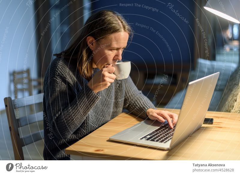Woman working on laptop at home woman computer sitting lifestyle businesswoman typing person female indoor internet technology adult using wireless table
