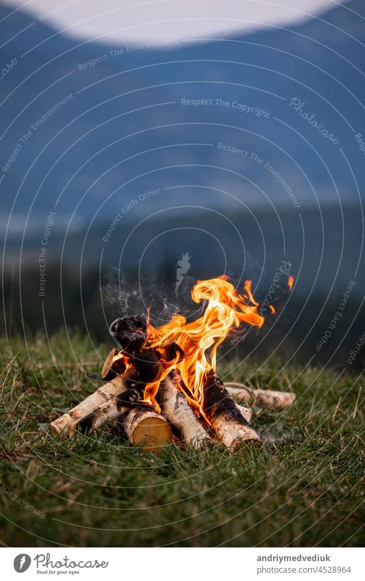 Burning bonfire in the evening in the Carpathian mountains. Place for inscription smoke adventure tourism flame burn background beautiful blaze camp campfire