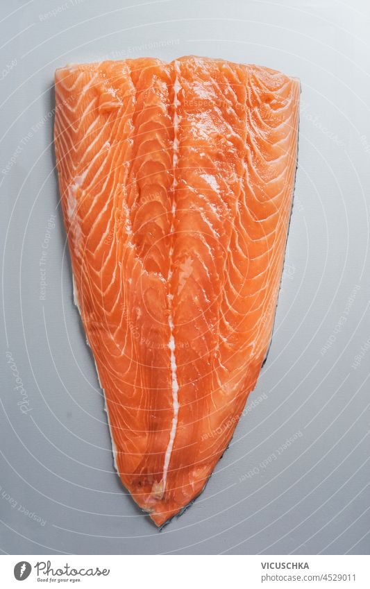 Raw salmon fillet on pale grey background. Top view. raw top view backgrounds cooking cuisine fish food fresh freshness gourmet health healthy food ingredient