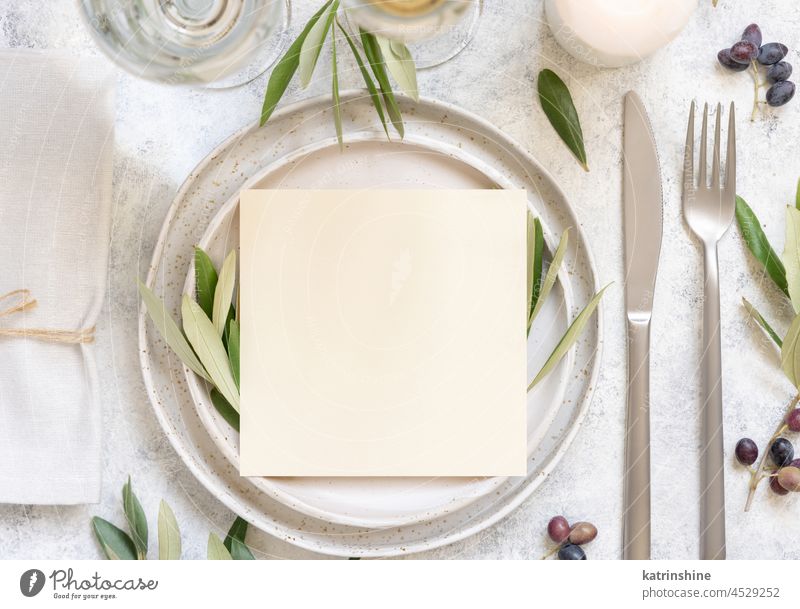 Wedding Table place with a card decorated with olive branches Card Blank mockup plate leaf fruit invitaion White green Leaves Mediterranean top view
