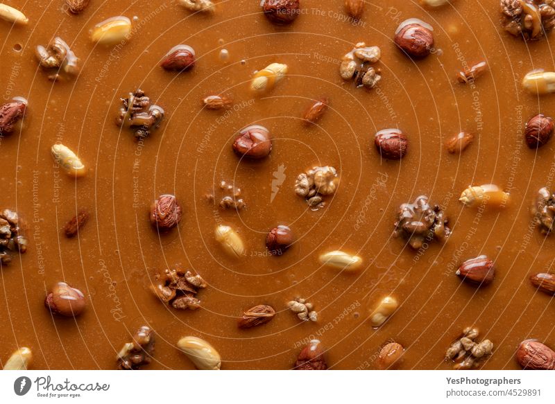 Caramel sauce and nuts background. Texture of melted caramel above view almonds baking brittle butterscotch caramelized christmas confectionery cooking cream