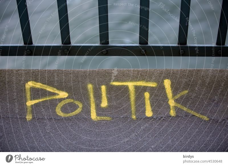 Politics , yellow lettering on a bridge policy Word writing Politics and state Graffiti Letters (alphabet) Characters Parties Government politically parapet