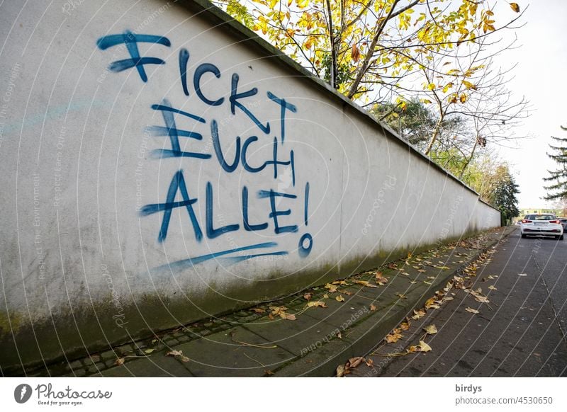 "Fuck you all !" angry graffiti on a wall along a street. Writing fuck you fuck you ! Anger Vulgar Frustration German Characters Text Argument Aggravation