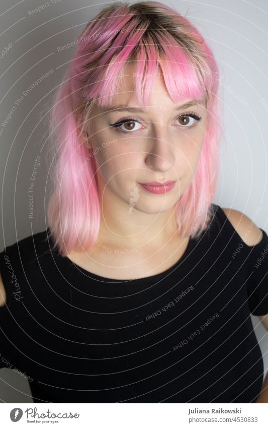 Portrait of a young woman with pink hair pit cute Girl teenager fashion photography Fashion black T-shirt Facial expression Make-up make-up Bangs eyeliner