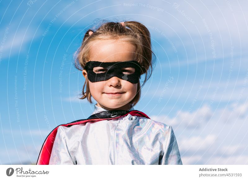 Girl in eye mask and superhero costume girl kid portrait carnival childhood fantasy brave pretend human face innocent imagination cape individuality cute power